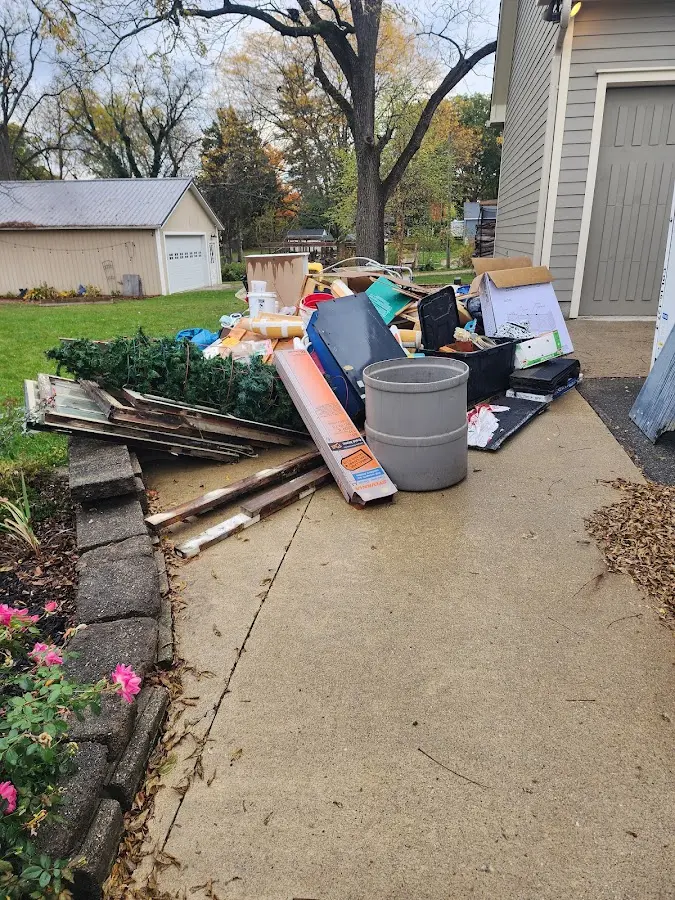 Dumpster being loaded with debris for Estate Cleanout Dumpster Rental in Highland Park